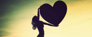 silhouette-of-woman-holding-big-heart