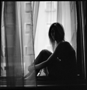 Girl Sitting in Window