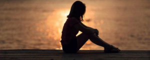 Girl Sitting On Beach
