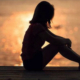 Girl Sitting On Beach