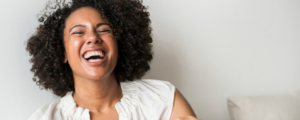 Canva - Smiling Woman Sitting on the Bed (banner)