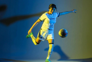 Girl kicking soccer ball
