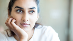Indian woman with hand on chin