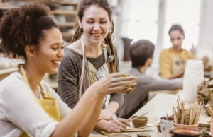 Teens doing pottery laughing