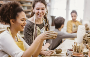 Teens doing pottery laughing