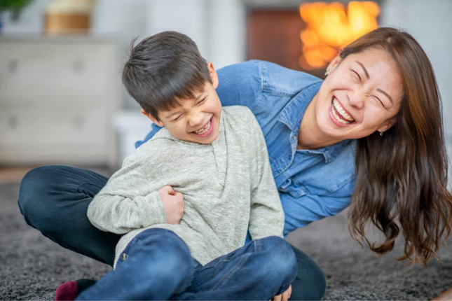 Mother with eating disorder laughing with her son