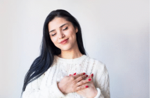 Woman with hands on heart