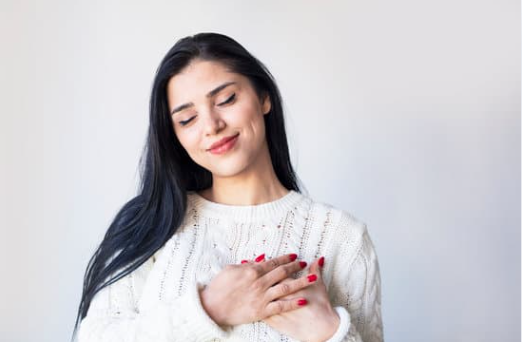 Woman with hands on heart